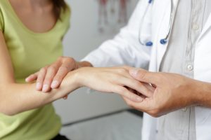 Patient receiving help for their hand neuropathy