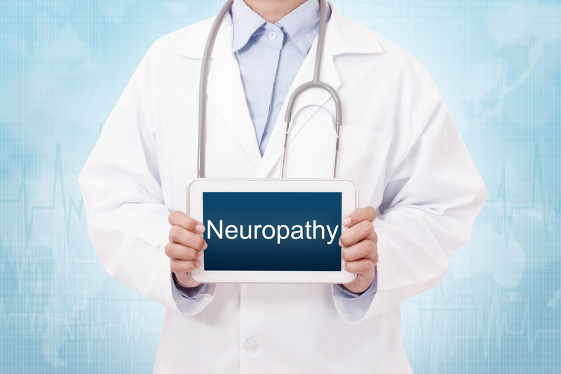 Doctor holding up a sign that says "neuropathy"